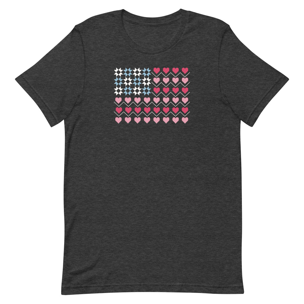 United We Quilt patchwork flag with quilt-block stars and heart stripes on a t-shirt in dark grey heather, front view – Kate Spain design for Pat Sloan