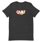 Moda QUILT logo with orange, pink, blue and yellow rays on a staple t-shirt in dark grey heather, front view – Kate Spain design
