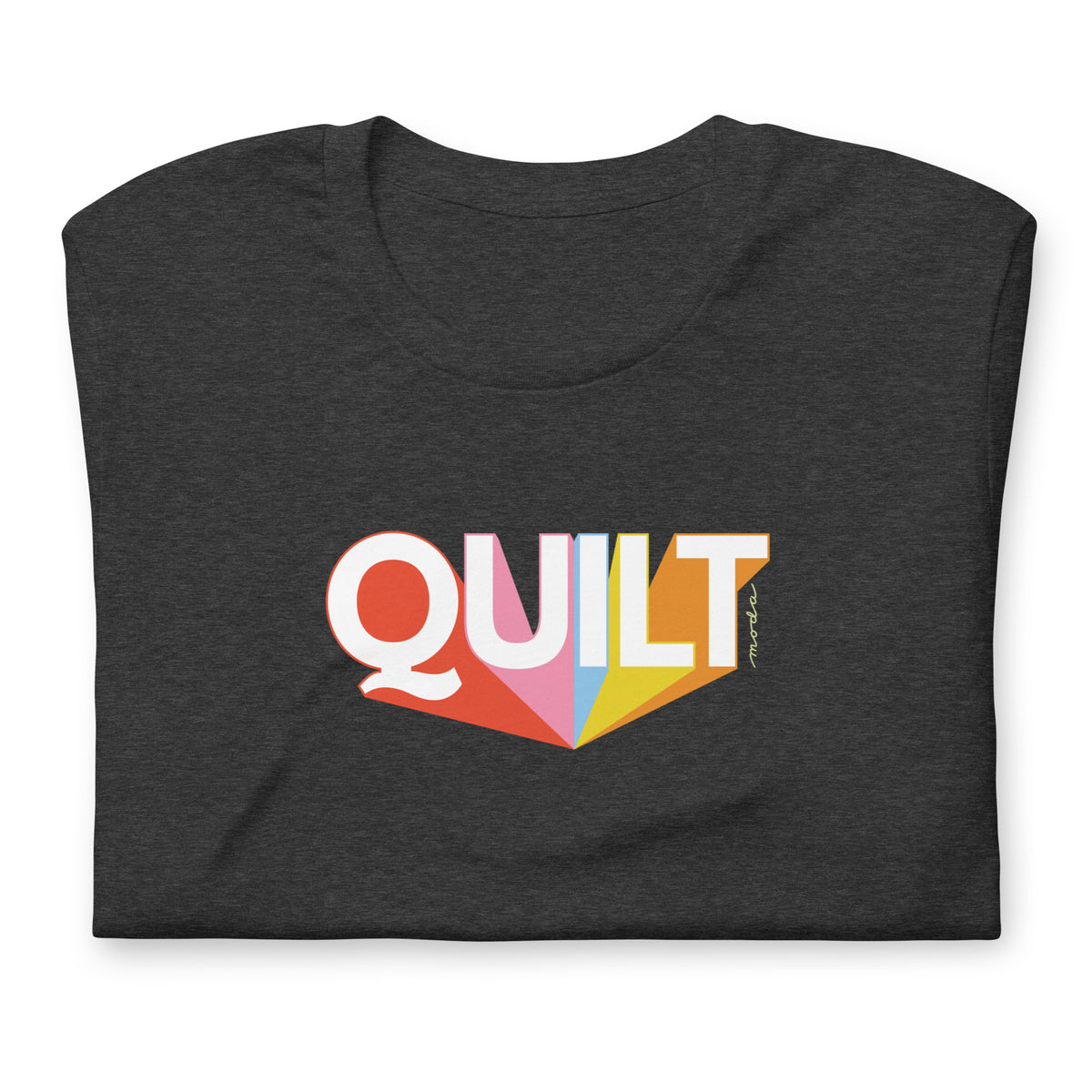 Moda QUILT logo with orange, pink, blue and yellow rays on a staple t-shirt in dark grey heather, folded close-up of the design – Kate Spain design