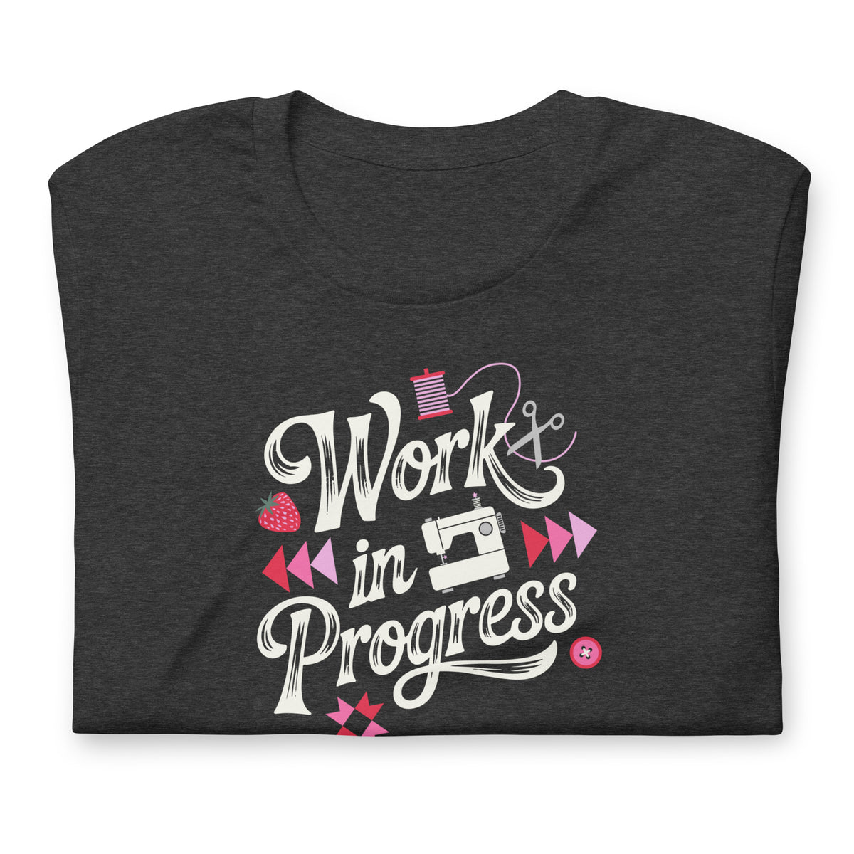 Work in Progress sewing design with flying geese, sewing machine, strawberry and thread spool on a t-shirt in dark grey heather, folded close-up of the design – Kate Spain design for Pat Sloan