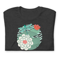 Dragonfly over water lilies and lily pads on a t-shirt in dark grey heather, folded close-up of the design – Kate Spain design