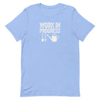 Garden Work in Progress distressed lettering with a shovel, pitchfork and watering can on a t-shirt in heather Carolina blue, front view – Kate Spain design