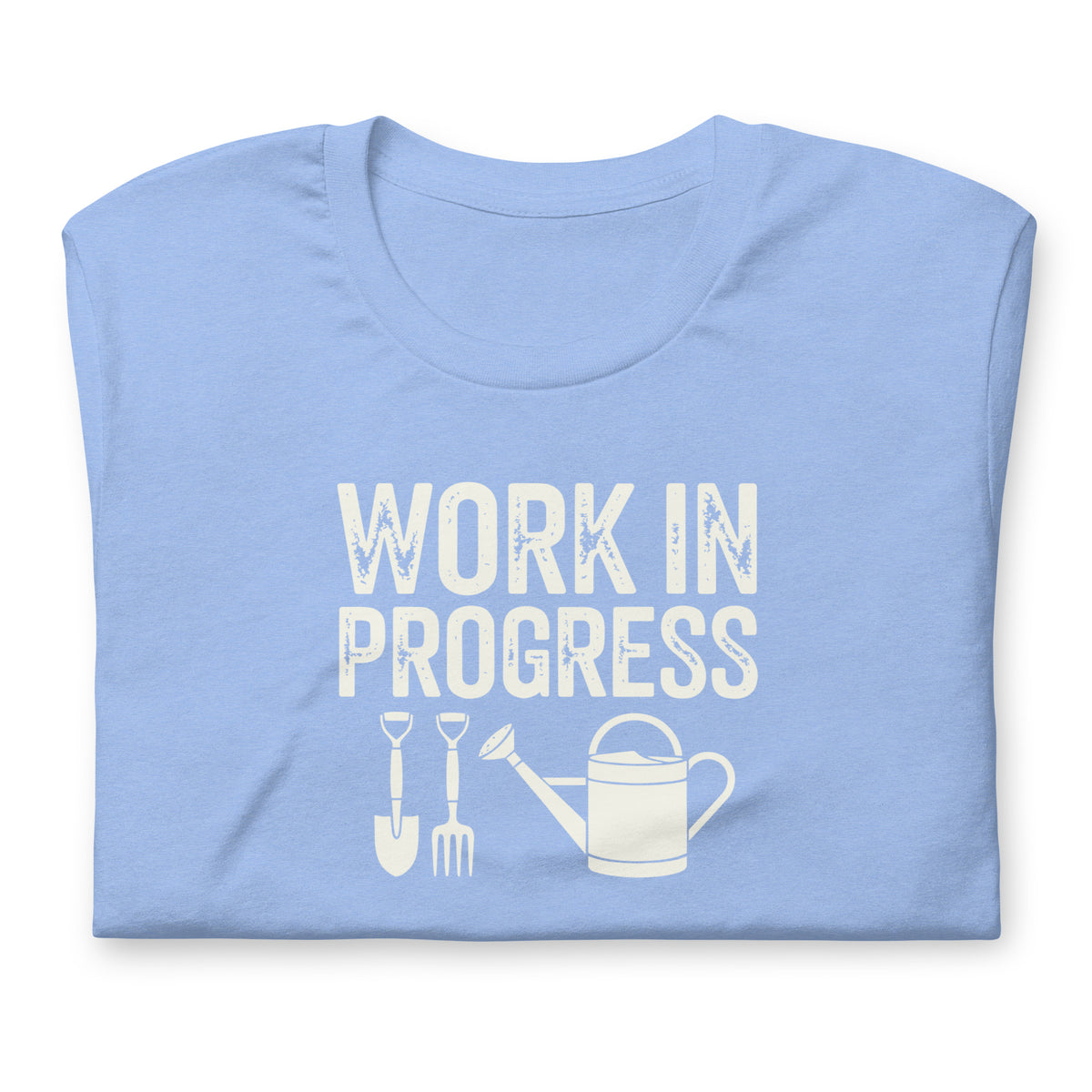 Garden Work in Progress distressed lettering with a shovel, pitchfork and watering can on a t-shirt in heather Carolina blue, folded close-up of the design – Kate Spain design