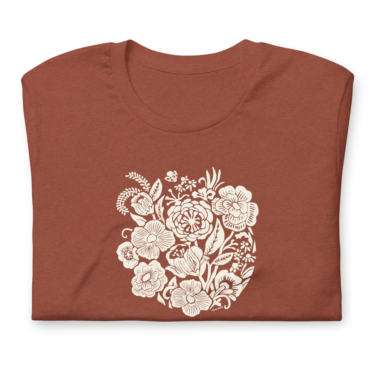 Meadowsweet woodblock-style bouquet of wildflowers on a t-shirt in heather clay, folded close-up of the design – Kate Spain design