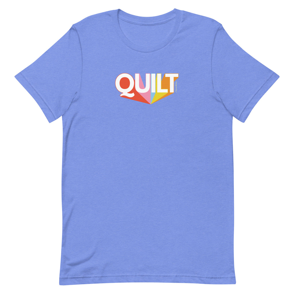 Moda QUILT logo with orange, pink, blue and yellow rays on a staple t-shirt in heather Columbia blue, front view – Kate Spain design