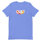 Moda QUILT logo with orange, pink, blue and yellow rays on a staple t-shirt in heather Columbia blue, front view – Kate Spain design