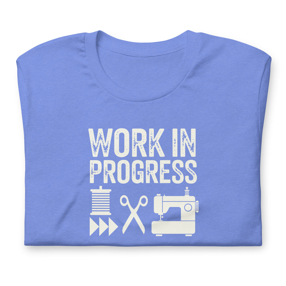 Work in Progress Mod distressed lettering with thread, scissors and sewing machine on a t-shirt in heather Columbia blue, folded close-up of the design – Kate Spain design for Pat Sloan
