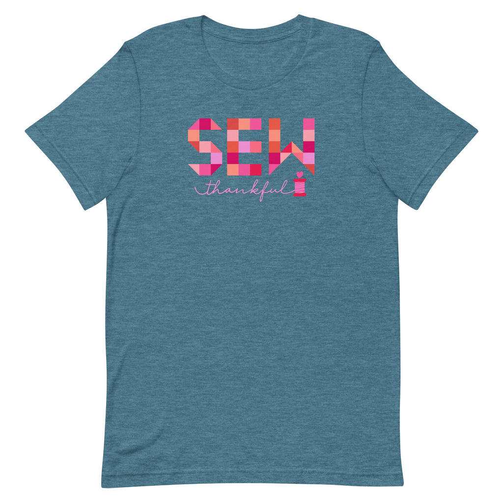Sew Thankful patchwork lettering with a heart-topped thread spool on a t-shirt in heather deep teal, front view – Kate Spain design for Pat Sloan