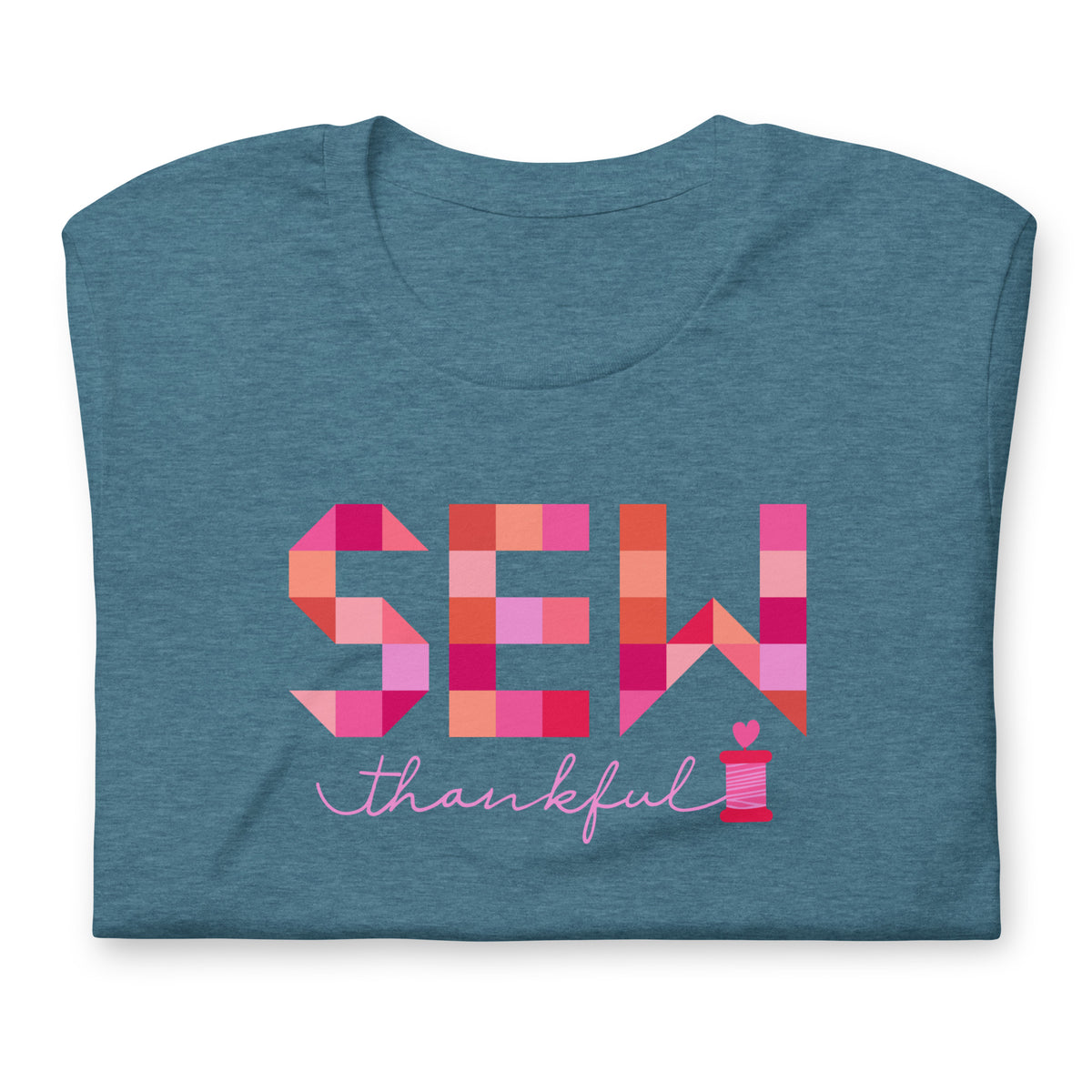 Sew Thankful patchwork lettering with a heart-topped thread spool on a t-shirt in heather deep teal, folded close-up of the design – Kate Spain design for Pat Sloan