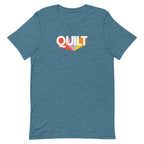 Moda QUILT logo with orange, pink, blue and yellow rays on a staple t-shirt in heather deep teal, front view – Kate Spain design