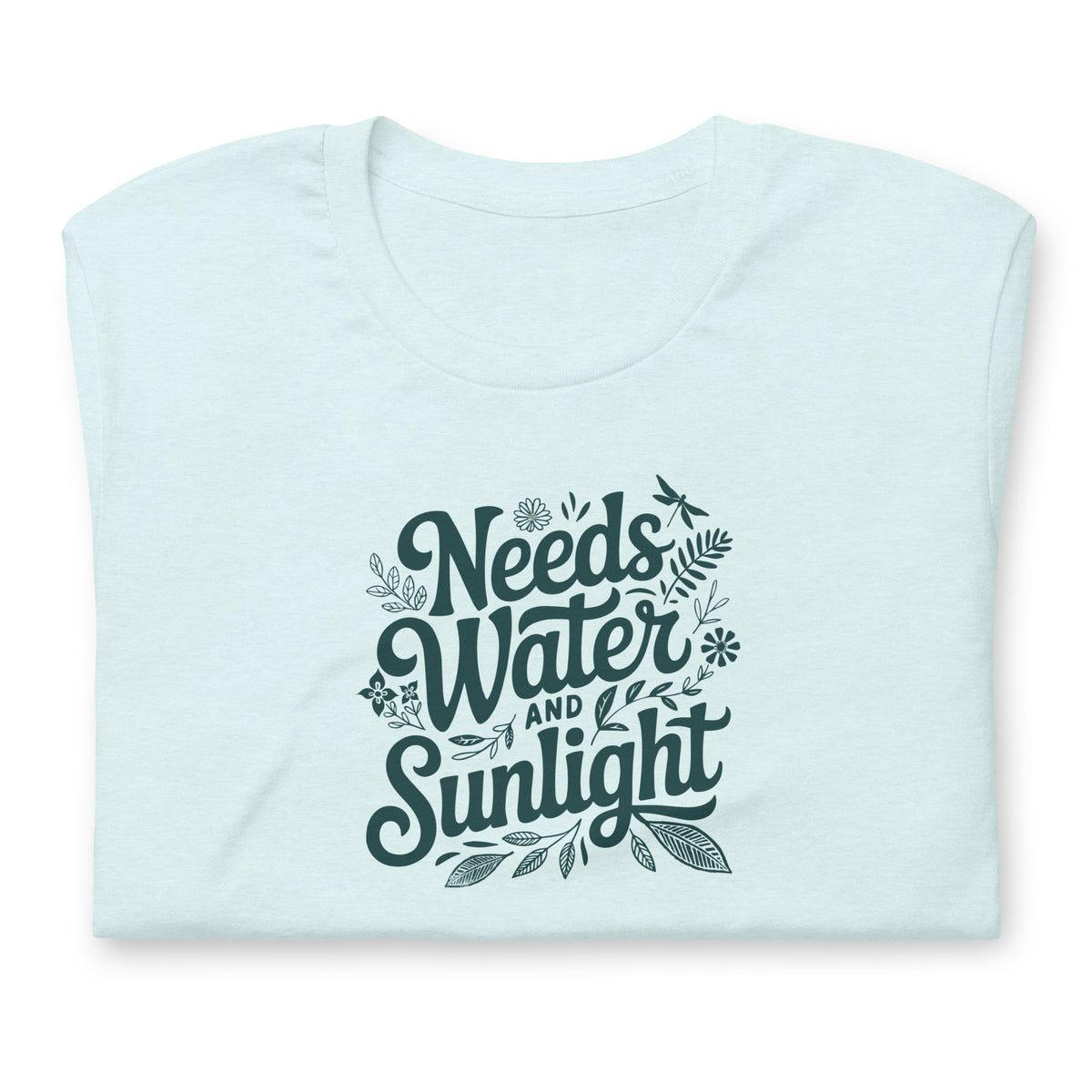 Needs Water + Sunlight hand lettering with leaf and sun accents on a t-shirt in heather ice blue, folded close-up of the design – Kate Spain design