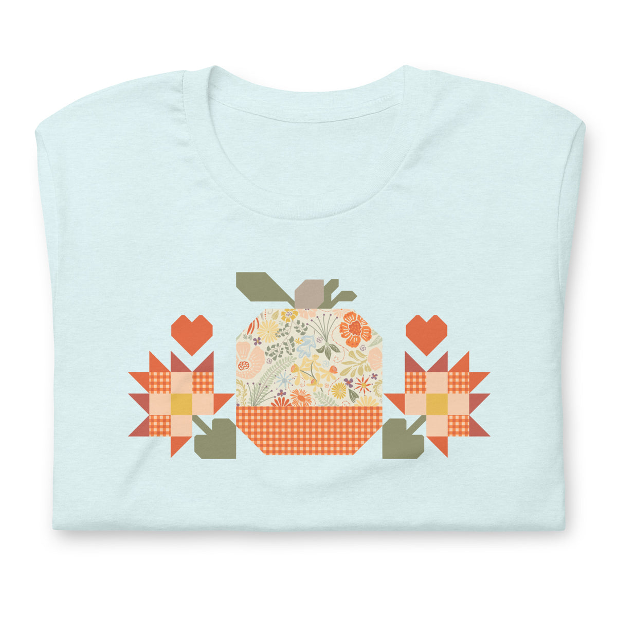 Falling for Fall patchwork pumpkin with quilt-block stars and hearts on a t-shirt in heather ice blue, folded close-up of the design – Kate Spain design for Pat Sloan