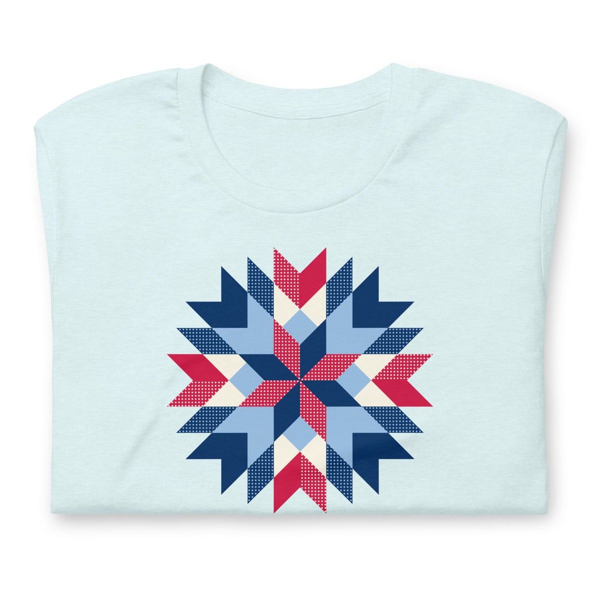 Barn Star quilt block in red, white and blue on a t-shirt in heather ice blue, folded close-up of the design – Kate Spain design for Pat Sloan