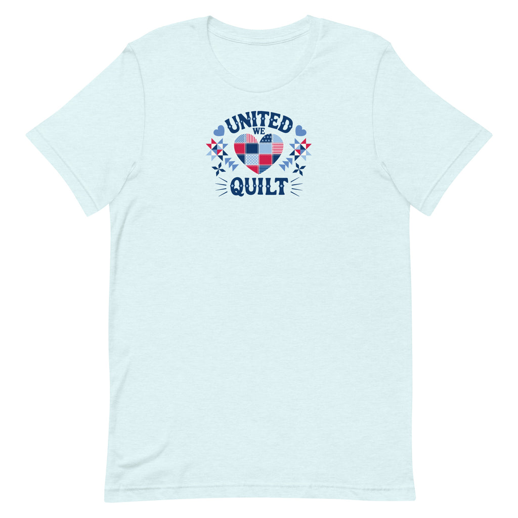 Quilters United quilt badge in red, white and blue on a t-shirt in heather ice blue, front view – Kate Spain design for Pat Sloan