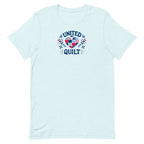 Quilters United quilt badge in red, white and blue on a t-shirt in heather ice blue, front view – Kate Spain design for Pat Sloan