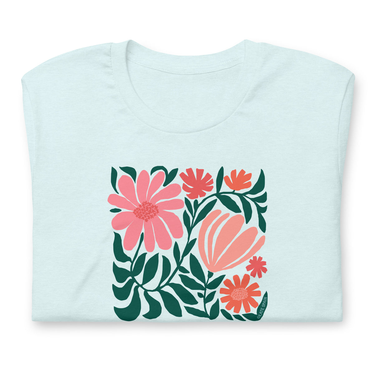 Botanica modern floral design with pink and coral blooms on a t-shirt in heather ice blue, folded close-up of the design – Kate Spain design