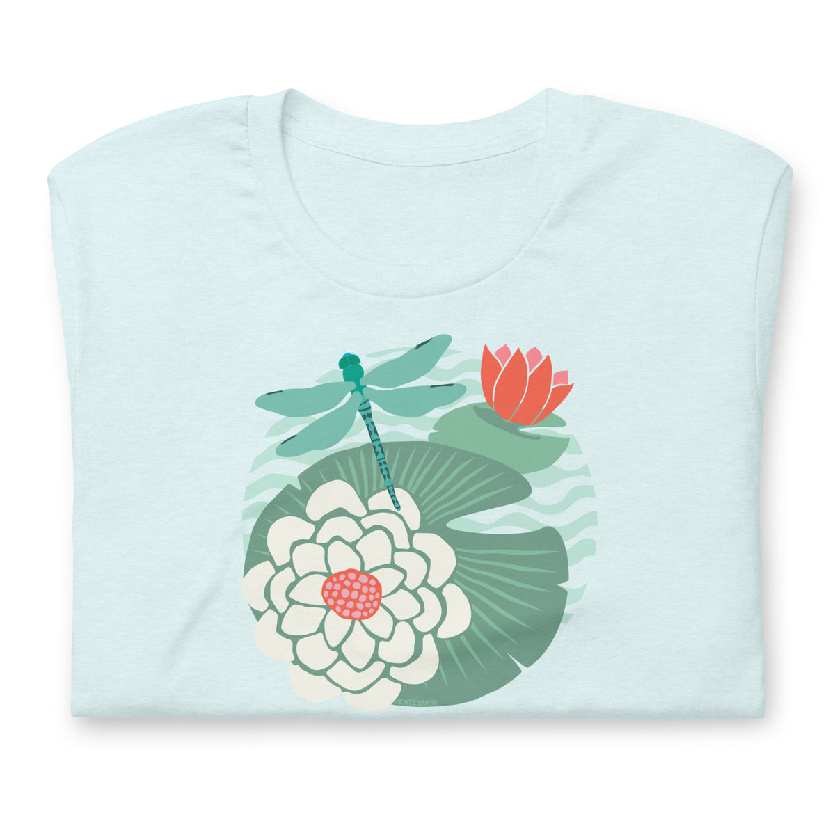 Dragonfly over water lilies and lily pads on a t-shirt in heather ice blue, folded close-up of the design – Kate Spain design