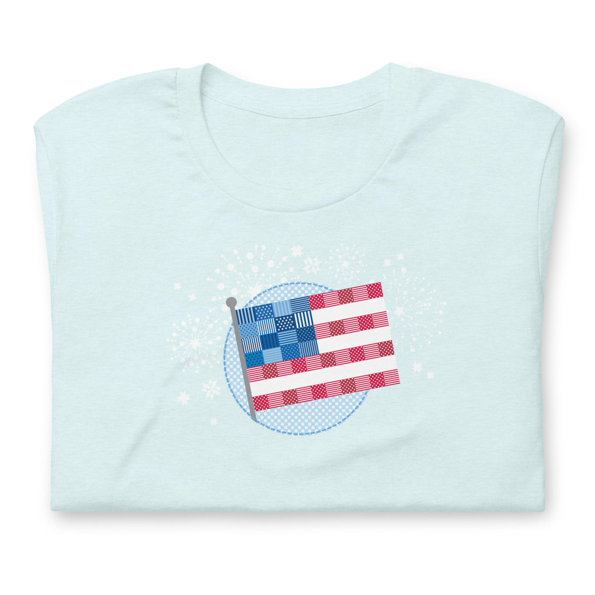 Patchwork Flag quilt-style flag with fireworks on a staple t-shirt in heather ice blue, folded close-up of the design – Kate Spain design for Pat Sloan
