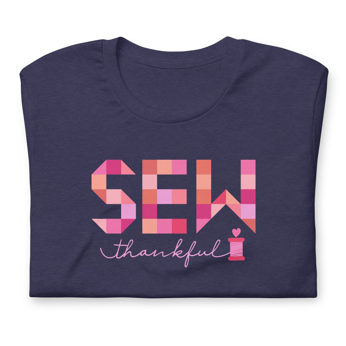 Sew Thankful patchwork lettering with a heart-topped thread spool on a t-shirt in heather navy, folded close-up of the design – Kate Spain design for Pat Sloan