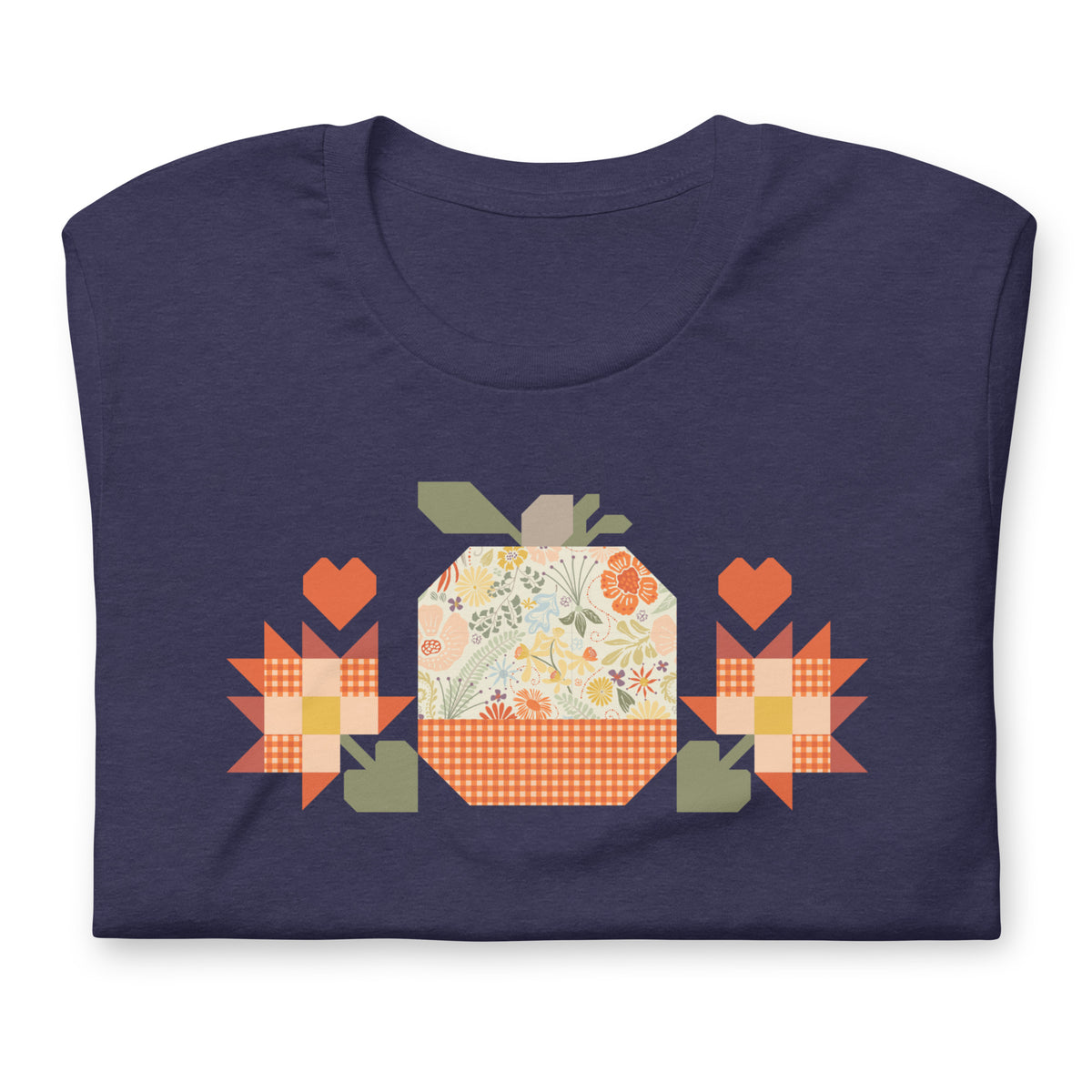 Falling for Fall patchwork pumpkin with quilt-block stars and hearts on a t-shirt in heather navy, folded close-up of the design – Kate Spain design for Pat Sloan