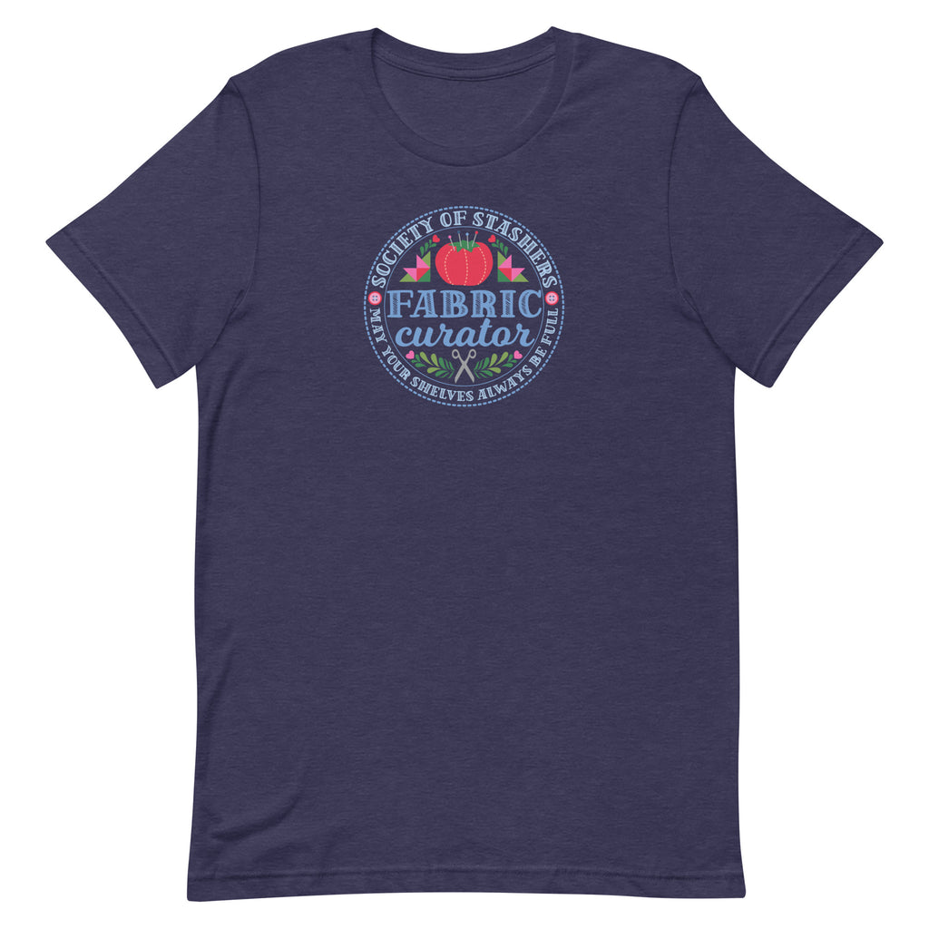 Fabric Curator Society of Stashers badge with a tomato pincushion on a t-shirt in heather navy, front view – Kate Spain design for Pat Sloan