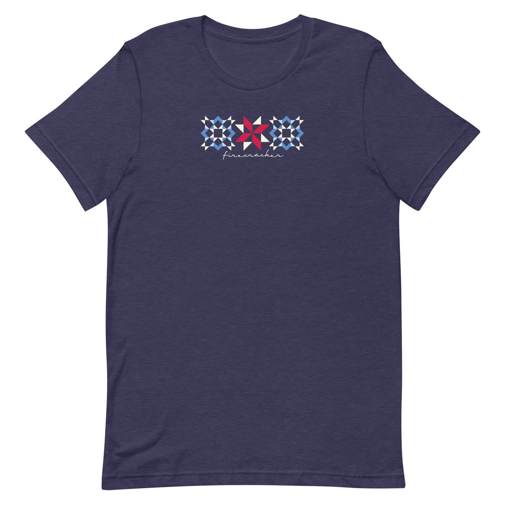 Firecracker quilt-block stars with script lettering in red, white and blue on a t-shirt in heather navy, front view – Kate Spain design for Pat Sloan