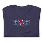 Firecracker quilt-block stars with script lettering in red, white and blue on a t-shirt in heather navy, folded close-up of the design – Kate Spain design for Pat Sloan