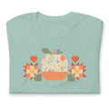 Falling for Fall patchwork pumpkin with quilt-block stars and hearts on a t-shirt in heather prism jade, folded close-up of the design – Kate Spain design for Pat Sloan