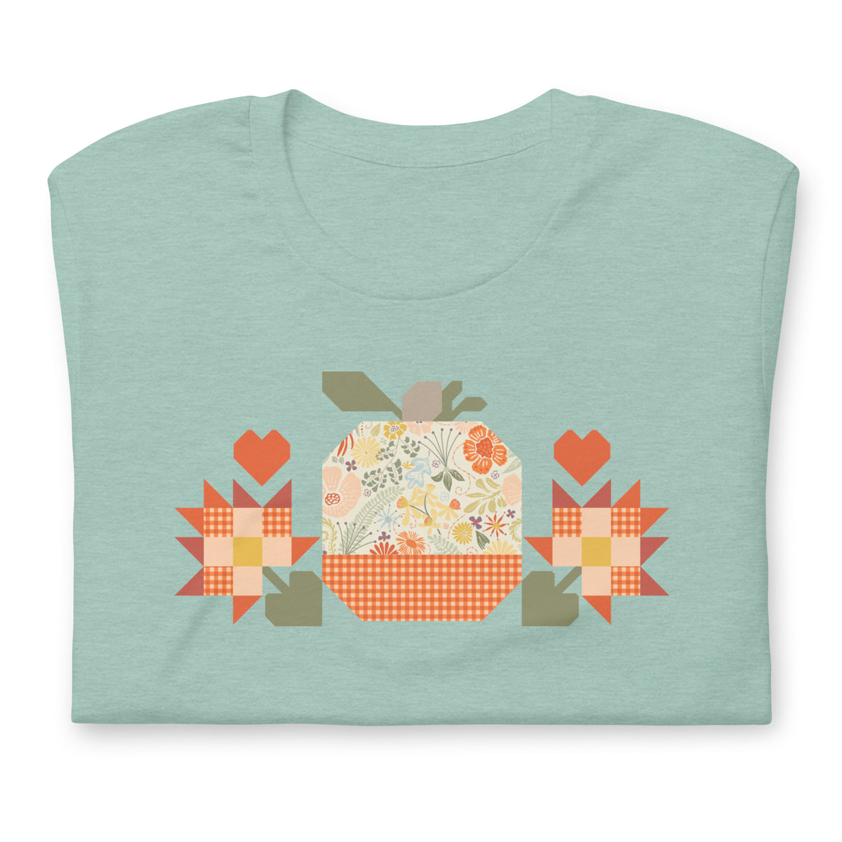 Falling for Fall patchwork pumpkin with quilt-block stars and hearts on a t-shirt in heather prism jade, folded close-up of the design – Kate Spain design for Pat Sloan