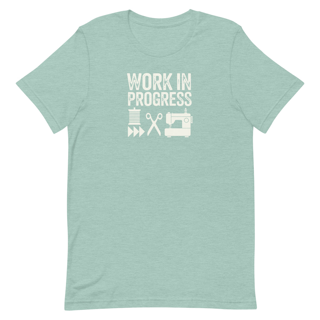 Work in Progress Mod distressed lettering with thread, scissors and sewing machine on a t-shirt in heather prism jade, front view – Kate Spain design for Pat Sloan