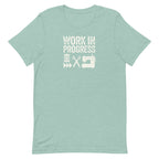 Work in Progress Mod distressed lettering with thread, scissors and sewing machine on a t-shirt in heather prism jade, front view – Kate Spain design for Pat Sloan