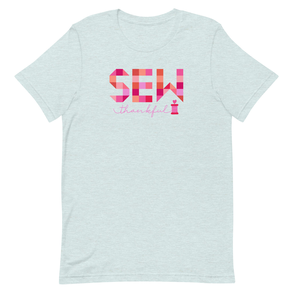 Sew Thankful patchwork lettering with a heart-topped thread spool on a t-shirt in heather prism ice blue, front view – Kate Spain design for Pat Sloan