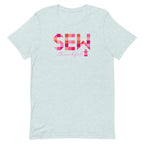 Sew Thankful patchwork lettering with a heart-topped thread spool on a t-shirt in heather prism ice blue, front view – Kate Spain design for Pat Sloan