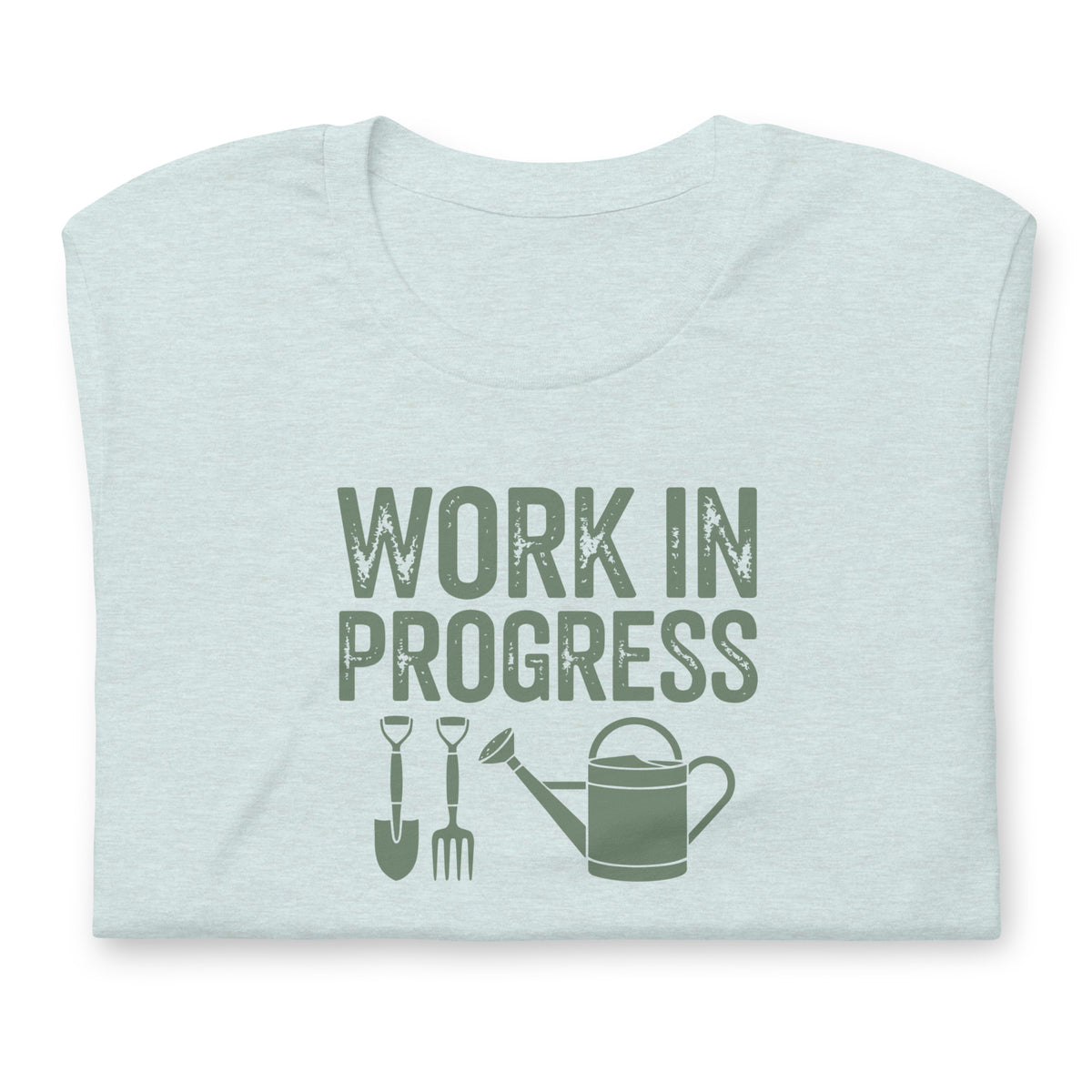 Garden Work in Progress distressed lettering with a shovel, pitchfork and watering can on a t-shirt in heather prism ice blue, folded close-up of the design – Kate Spain design