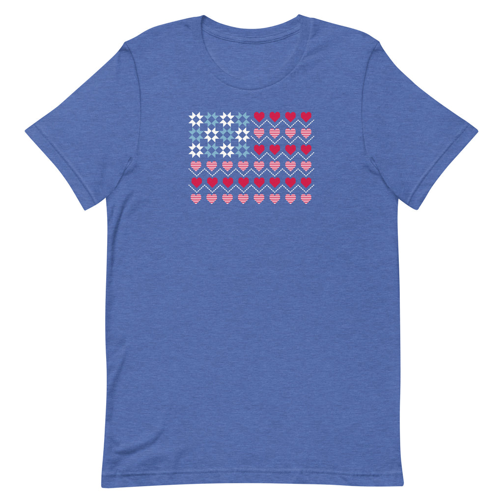 United We Quilt patchwork flag with quilt-block stars and heart stripes on a t-shirt in heather true royal, front view – Kate Spain design for Pat Sloan