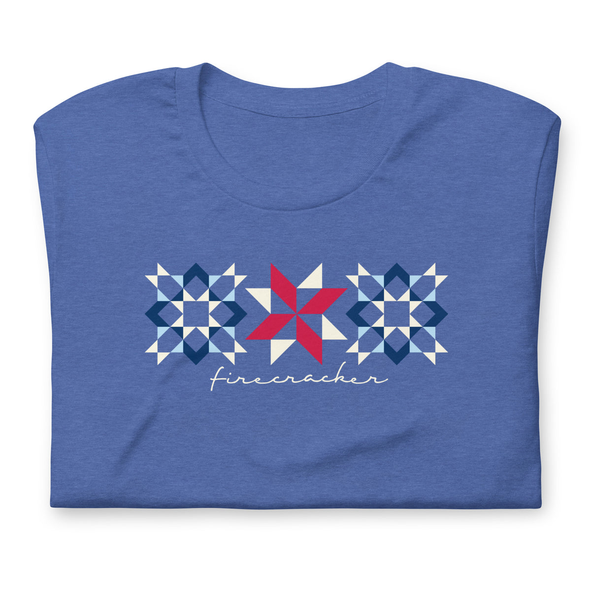 Firecracker quilt-block stars with script lettering in red, white and blue on a t-shirt in heather true royal, folded close-up of the design – Kate Spain design for Pat Sloan