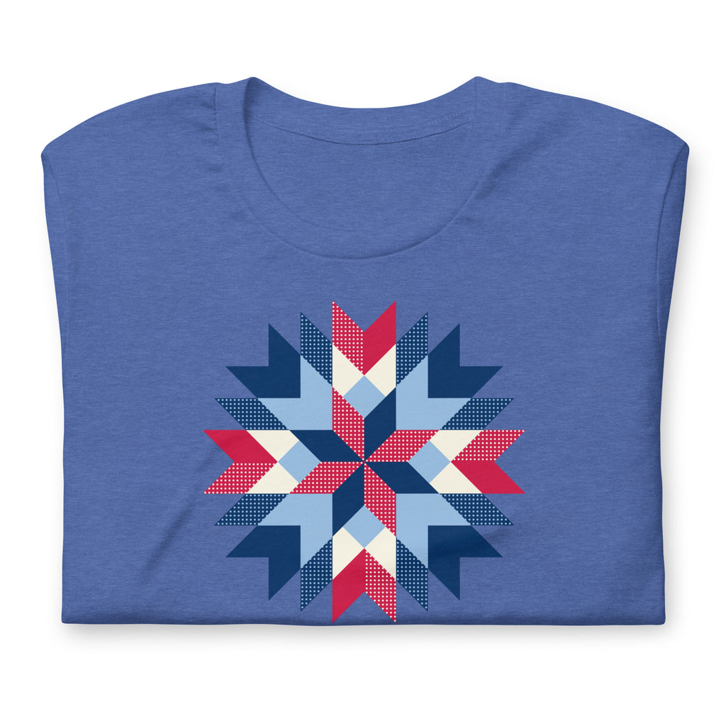 Barn Star quilt block in red, white and blue on a staple t-shirt in heather true royal blue, folded close-up of the design – Kate Spain design for Pat Sloan