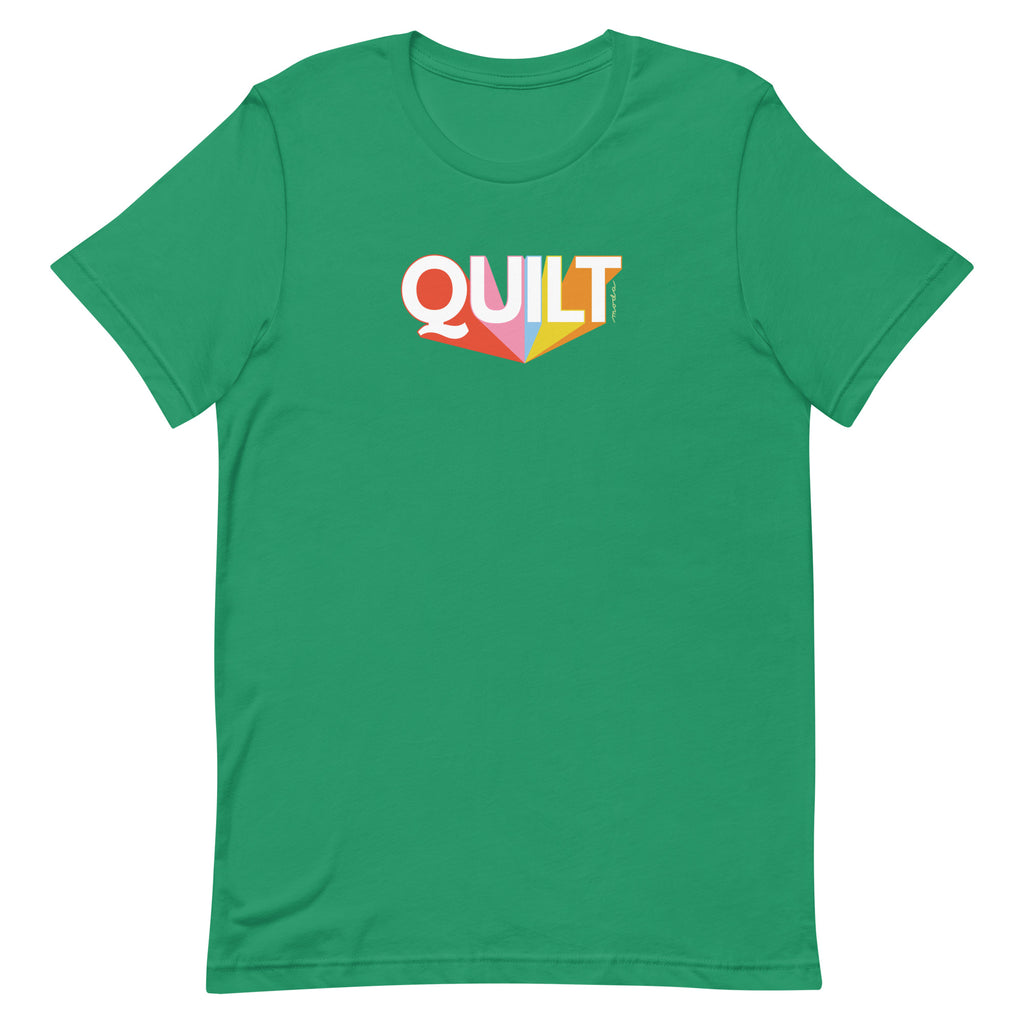 Moda QUILT logo with orange, pink, blue and yellow rays on a staple t-shirt in kelly green, front view – Kate Spain design
