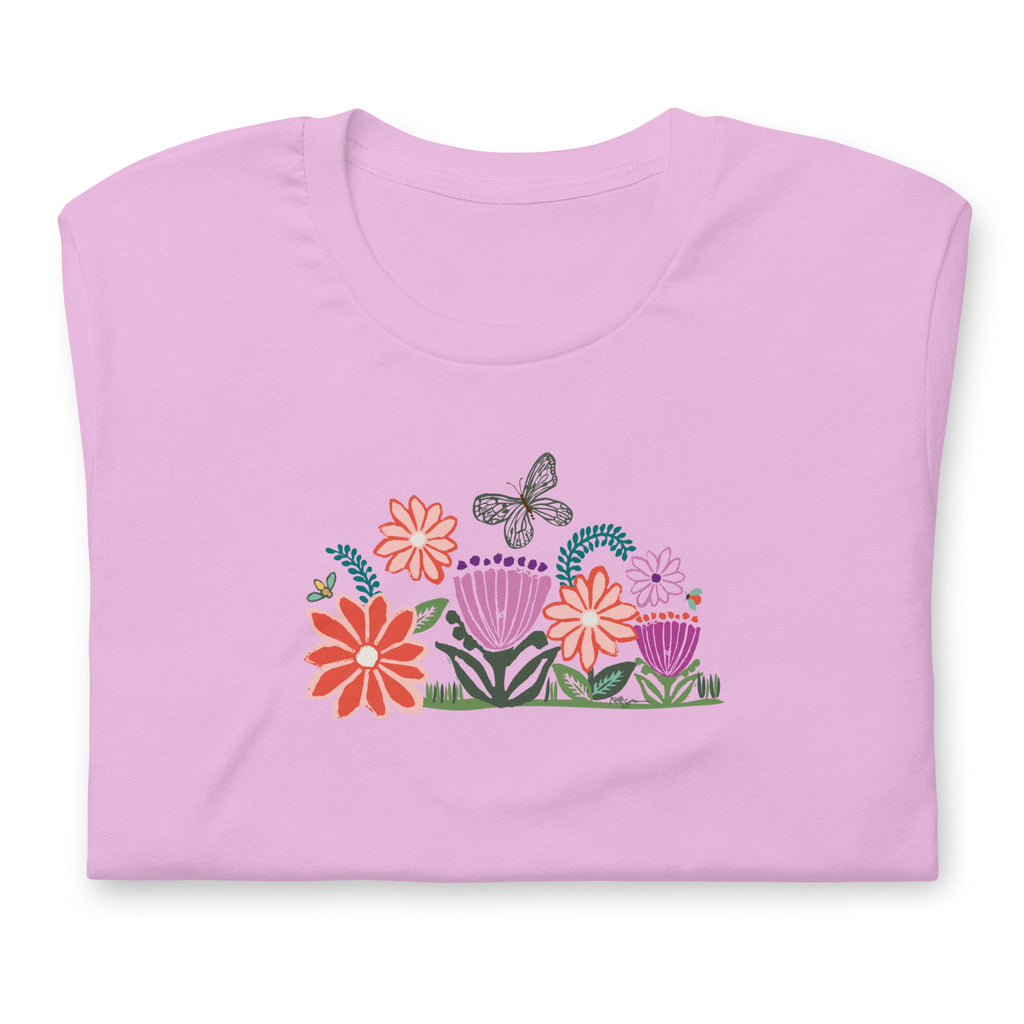 Bloom woodblock-style flowers with a butterfly, ladybug and bee on a t-shirt in lilac, folded close-up of the design – Kate Spain design