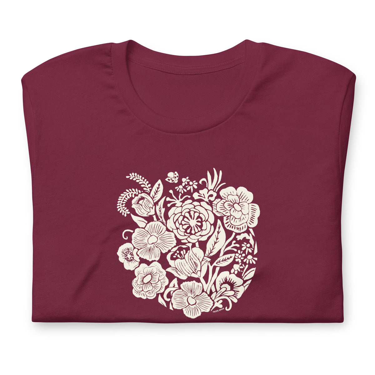 Meadowsweet woodblock-style bouquet of wildflowers on a t-shirt in maroon, folded close-up of the design – Kate Spain design