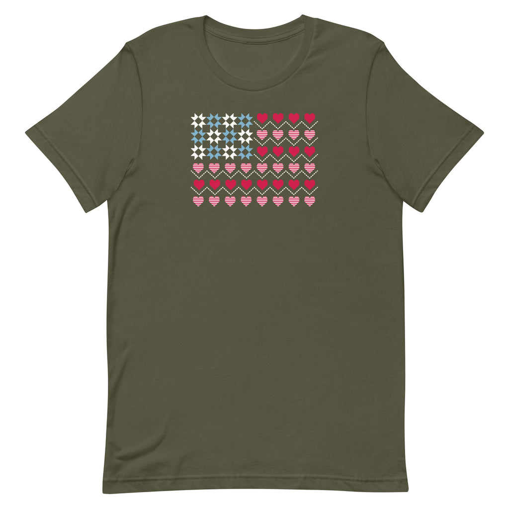 United We Quilt patchwork flag with quilt-block stars and heart stripes on a t-shirt in military green, front view – Kate Spain design for Pat Sloan