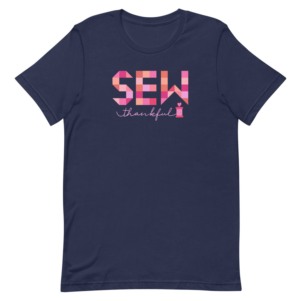 Sew Thankful patchwork lettering with a heart-topped thread spool on a t-shirt in navy, front view – Kate Spain design for Pat Sloan