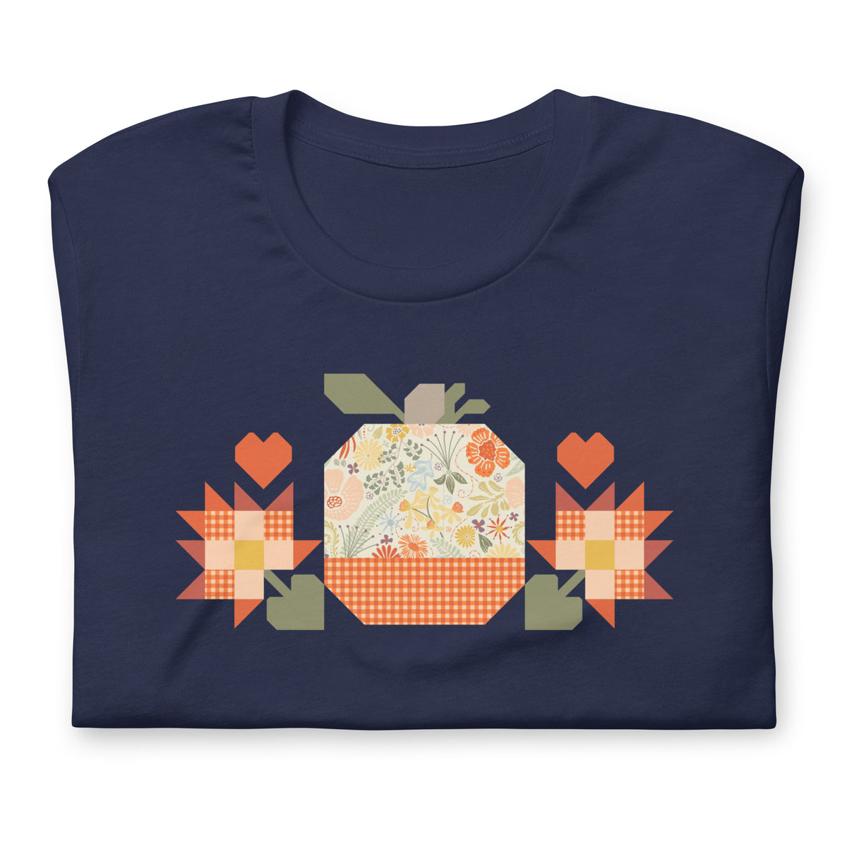 Falling for Fall patchwork pumpkin with quilt-block stars and hearts on a t-shirt in navy, folded close-up of the design – Kate Spain design for Pat Sloan