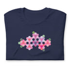 Pink GeoFlora hexagon flowers in pinks, mauves and sage on a t-shirt in navy, folded close-up of the design – Kate Spain design for Pat Sloan