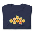 Yellow GeoFlora hexagon flowers in golden yellow, orange, coral and sage on a t-shirt in navy, folded close-up of the design – Kate Spain design for Pat Sloan