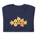 Yellow GeoFlora hexagon flowers in golden yellow, orange, coral and sage on a t-shirt in navy, folded close-up of the design – Kate Spain design for Pat Sloan
