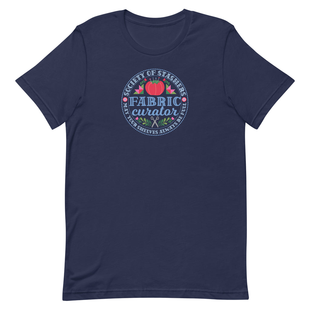 Fabric Curator Society of Stashers badge with a tomato pincushion on a t-shirt in navy, front view – Kate Spain design for Pat Sloan