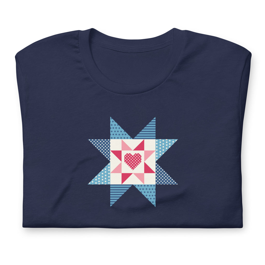 Liberty Love star quilt block with a heart in red, white and blue on a t-shirt in navy, folded close-up of the design – Kate Spain design for Pat Sloan