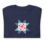 Liberty Love star quilt block with a heart in red, white and blue on a t-shirt in navy, folded close-up of the design – Kate Spain design for Pat Sloan