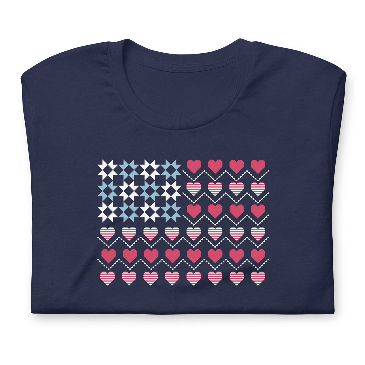 United We Quilt patchwork flag with quilt-block stars and heart stripes on a t-shirt in navy, folded close-up of the design – Kate Spain design for Pat Sloan